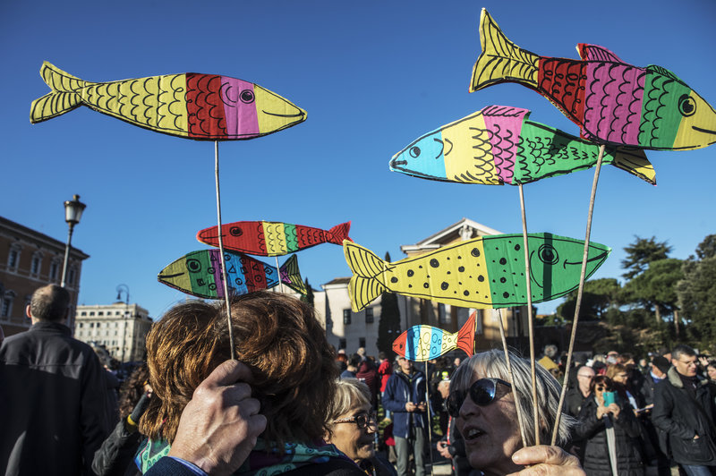 Sardine flags held by protesters in Italy.